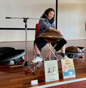 Alice Chi performing soothing handpan music at a wellness event in Wheelers Hill